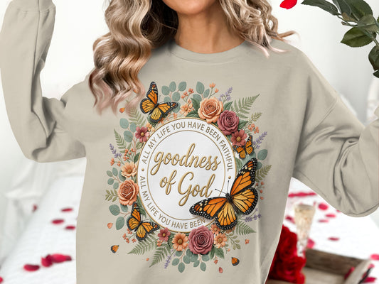 Beige sweatshirt with "goodness of God" and butterflies in a floral wreath.