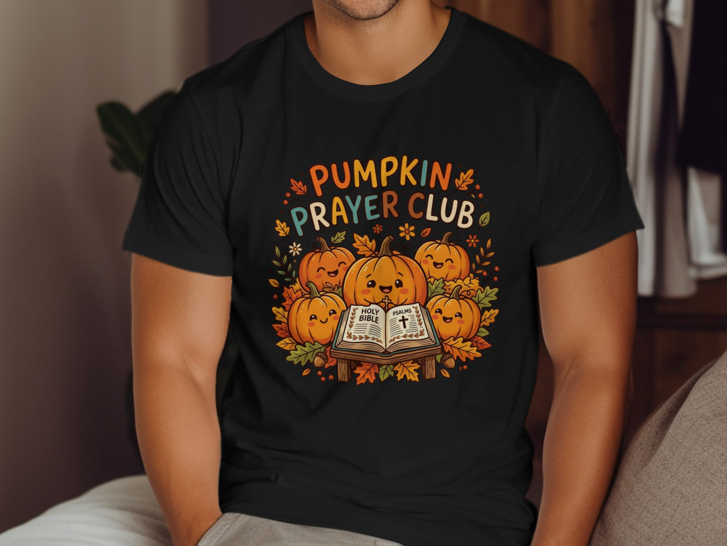 Black t-shirt with pumpkins reading a Bible, "Pumpkin Prayer Club" text.