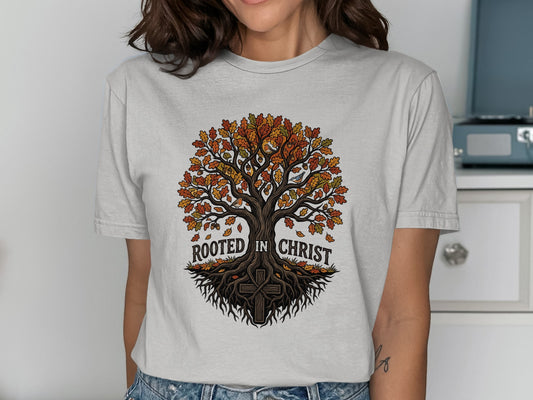 T-shirt graphic of a tree with roots and text "Rooted in Christ."