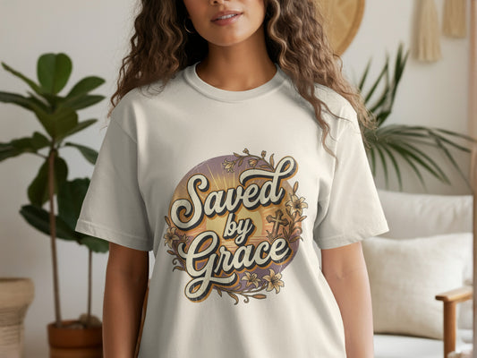 Cream t-shirt with "Saved by Grace" text and floral cross design.