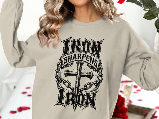 Cream sweatshirt with "Iron Sharpens Iron" text and cross with chains graphic.