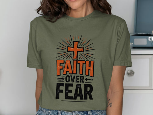 Olive green t-shirt with "Faith Over Fear" text and cross graphic.
