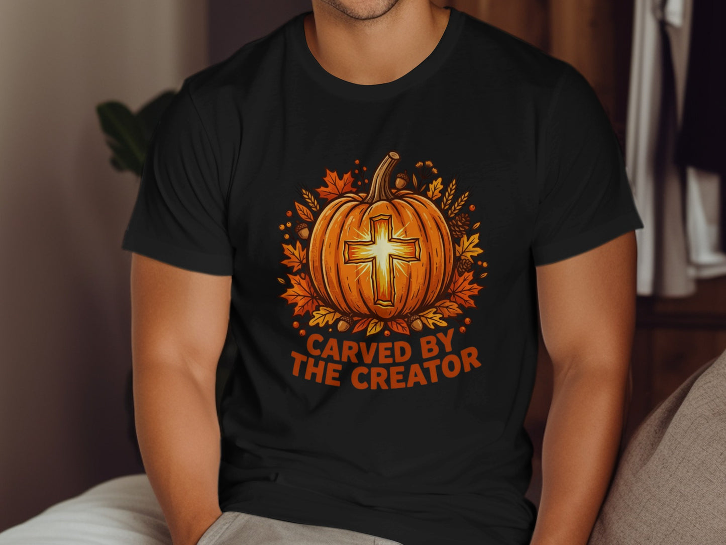 Black t-shirt with a pumpkin, cross, and autumn leaves, text "Carved by the Creator".