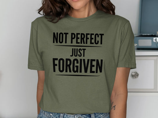 Green t-shirt with black text reading "NOT PERFECT JUST FORGIVEN".