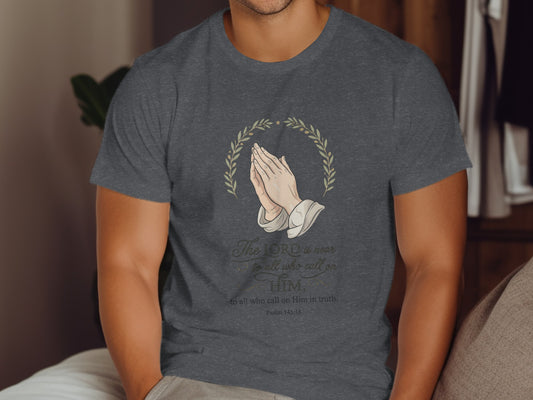 Dark grey t-shirt with praying hands, laurel wreath, and Bible verse "Psalm 145:18".