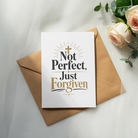 White card with gold text "Not Perfect, Just Forgiven" on a brown envelope.
