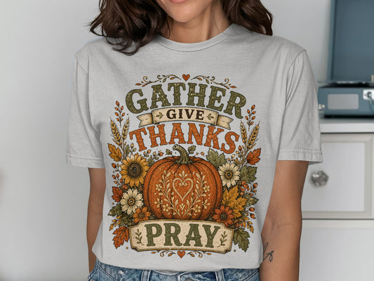GATHER GIVE THANKS PRAY text on t-shirt with pumpkin and floral wreath.