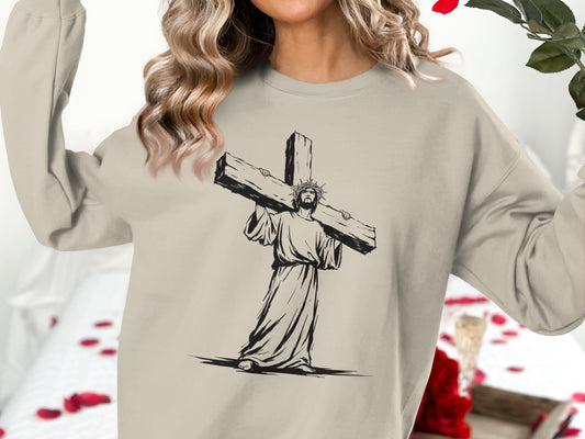 Jesus wearing a crown of thorns carries a wooden cross on his shoulder.