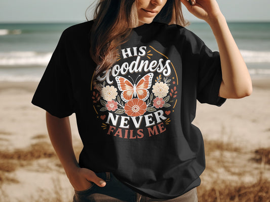 Black t-shirt with "His Goodness Never Fails Me" floral butterfly design.