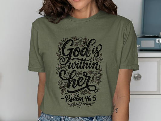 Olive green t-shirt with "God is within her - Psalm 46:5" floral design.