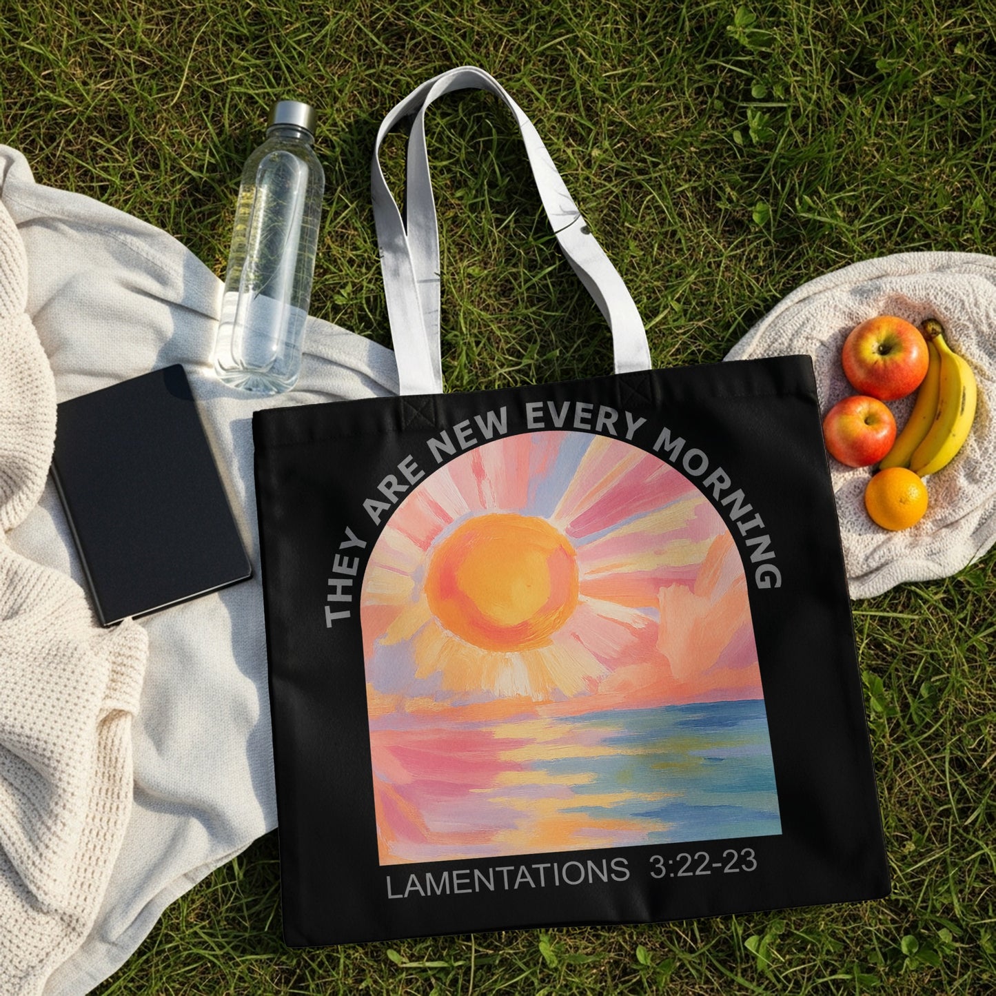 Black tote bag with a sunrise over water graphic and "They are new every morning Lamentations 3:22-23" text.
