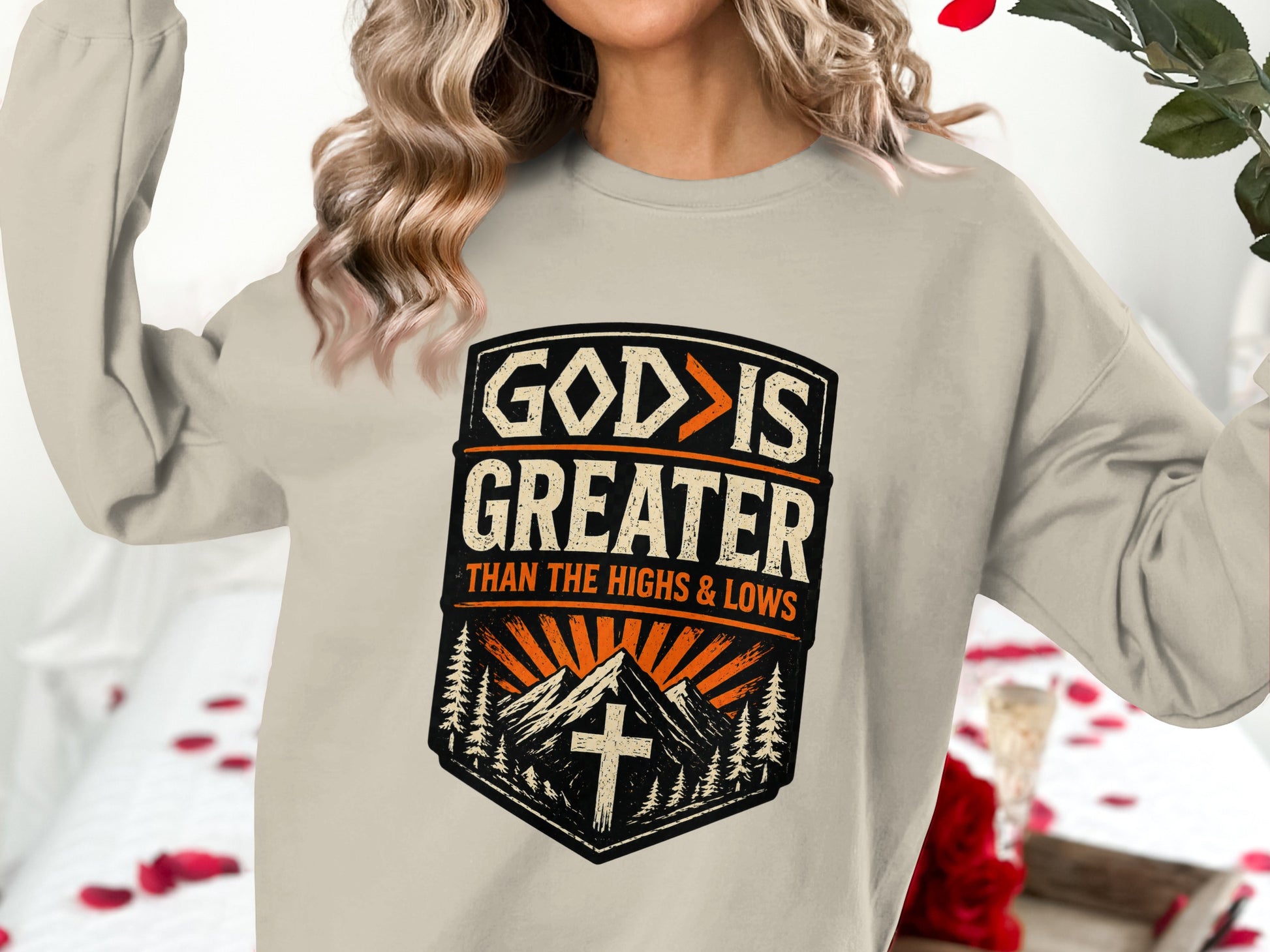 Crewneck sweatshirt with "God is greater than the highs and lows" graphic.