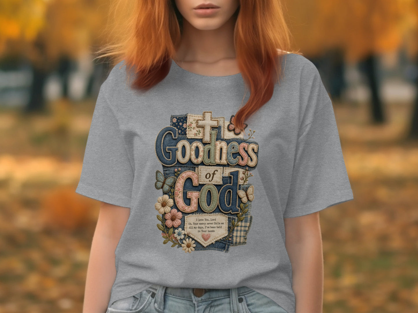 Grey t-shirt with "Goodness of God" text and floral cross design.