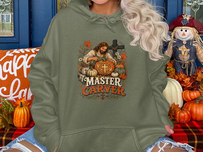 Hoodie with "Master Carver" text and carved pumpkins near a cross.