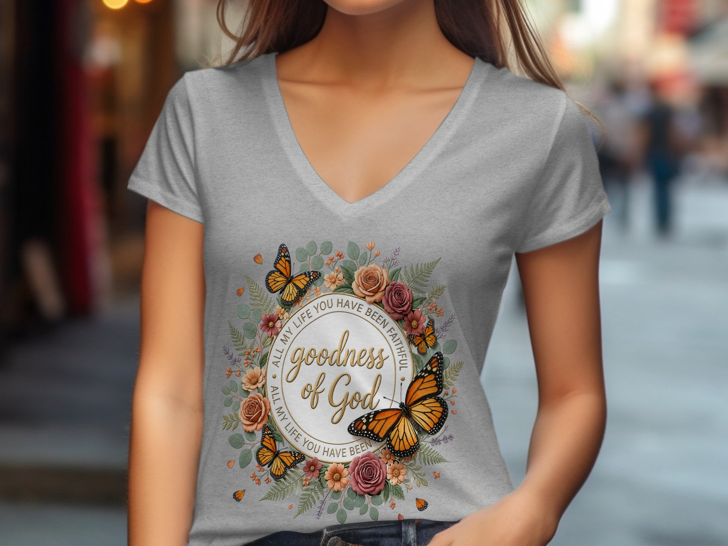 Grey v-neck t-shirt with floral and butterfly design and "Goodness of God" text.
