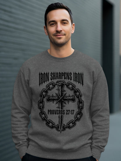 Man wearing a gray sweatshirt with "IRON SHARPENS IRON PROVERBS 27:17" and a cross design.