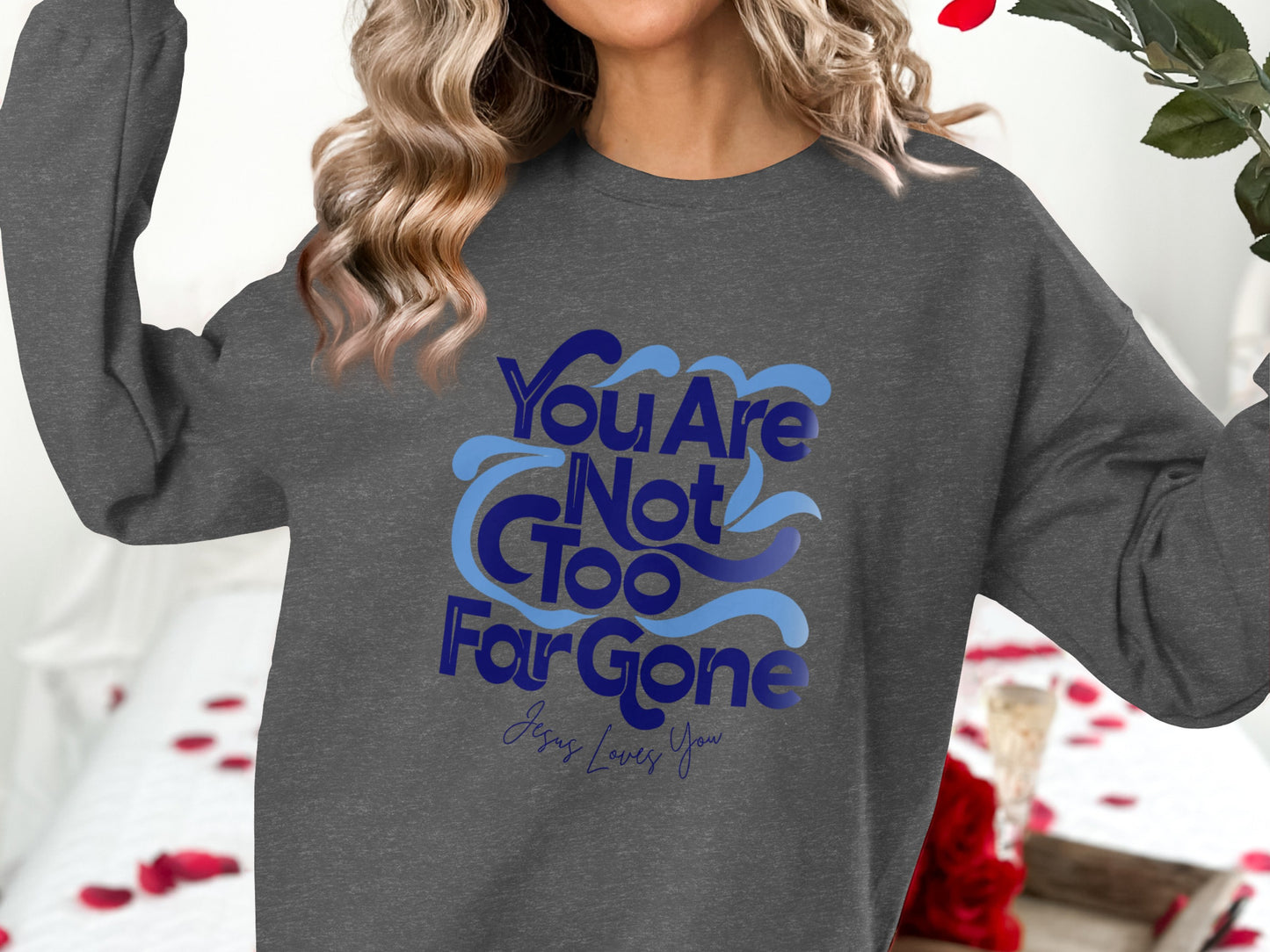 Dark gray crewneck sweatshirt with blue text "You Are Not Too Far Gone Jesus Loves You".