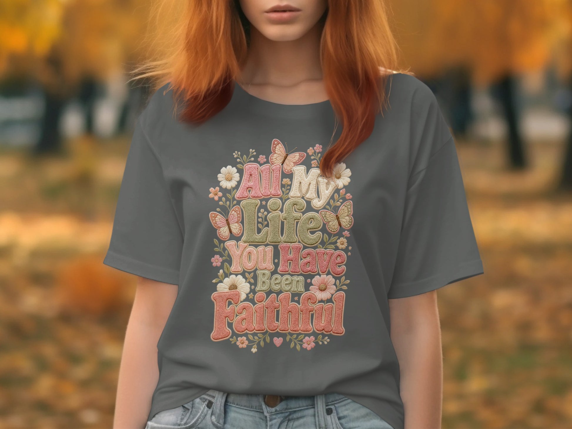 "All My Life You Have Been Faithful" text with floral and butterfly graphics on a gray t-shirt.