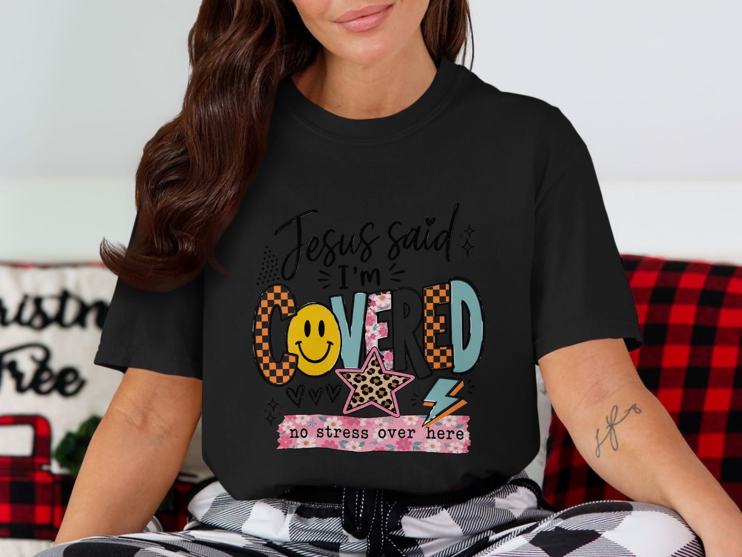 Black t-shirt with "Jesus said I'm COVERED no stress over here" graphic.