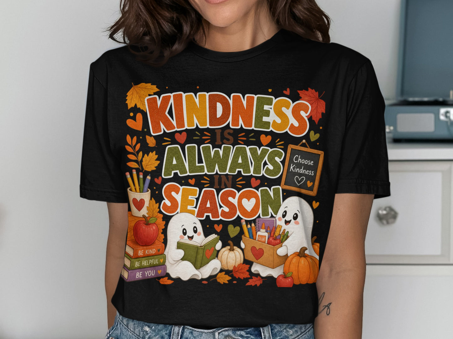 Black t-shirt with "Kindness is Always in Season" and two ghosts reading and holding school supplies.