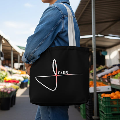 Black tote bag with a white abstract design and the word "Jesus" in white.