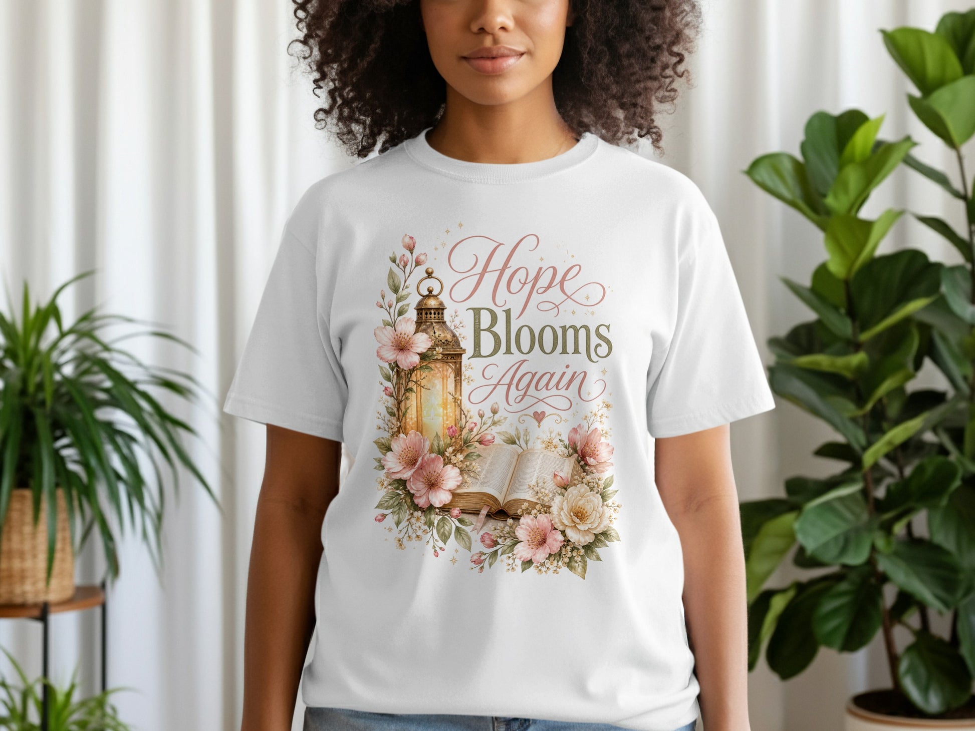 White t-shirt with a floral design and gold lantern, reading "Hope Blooms Again".