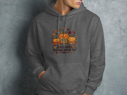 Dark gray hoodie featuring a graphic of pumpkins in scarves with text "Jesus Loves Pumpkin Season Too".