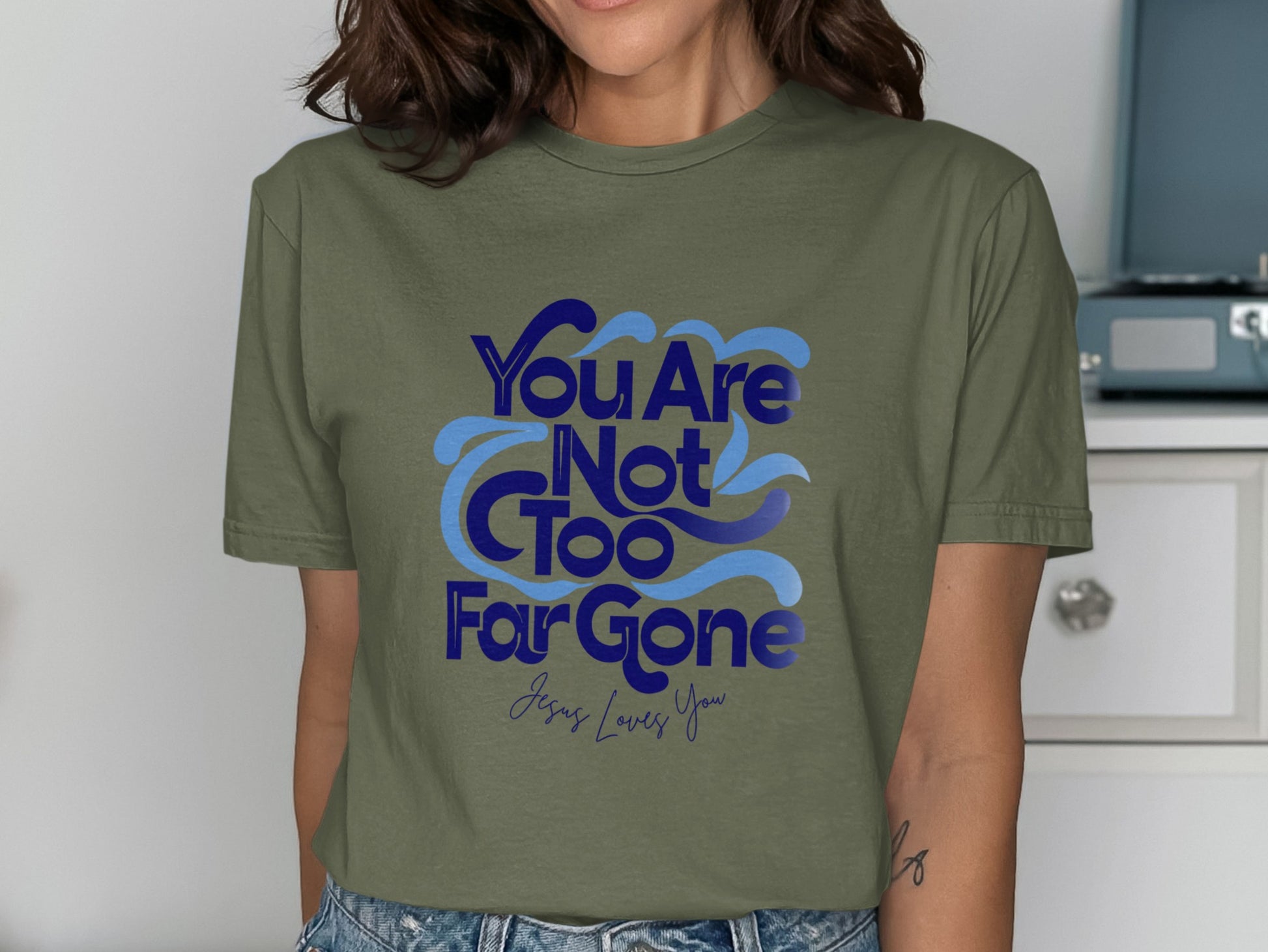 Olive t-shirt with blue text reading "You Are Not Too Far Gone Jesus Loves You".