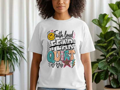 "Faith loud, fear quiet" graphic on a white t-shirt with smiley face and star accents.