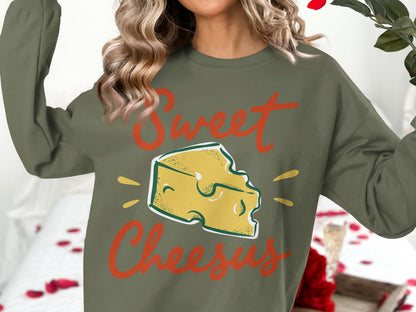Green sweatshirt with "Sweet Cheesus" text and cheese graphic.