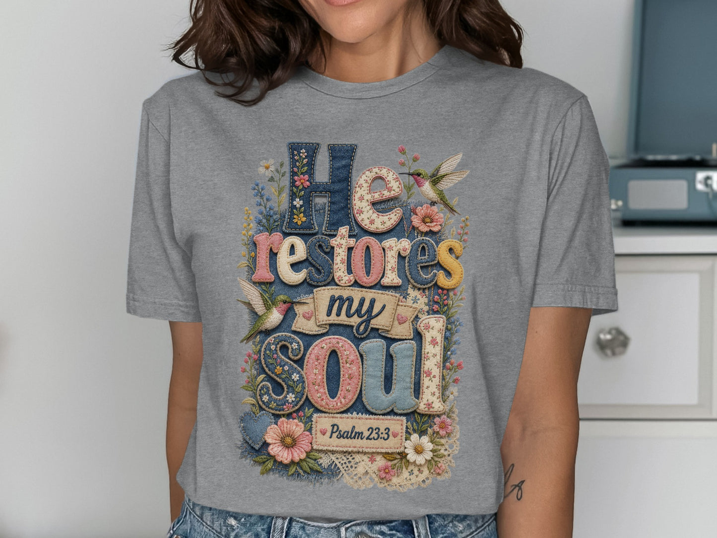 Grey t-shirt with "He Restores My Soul" in colorful, textured letters and Psalm 23:3.