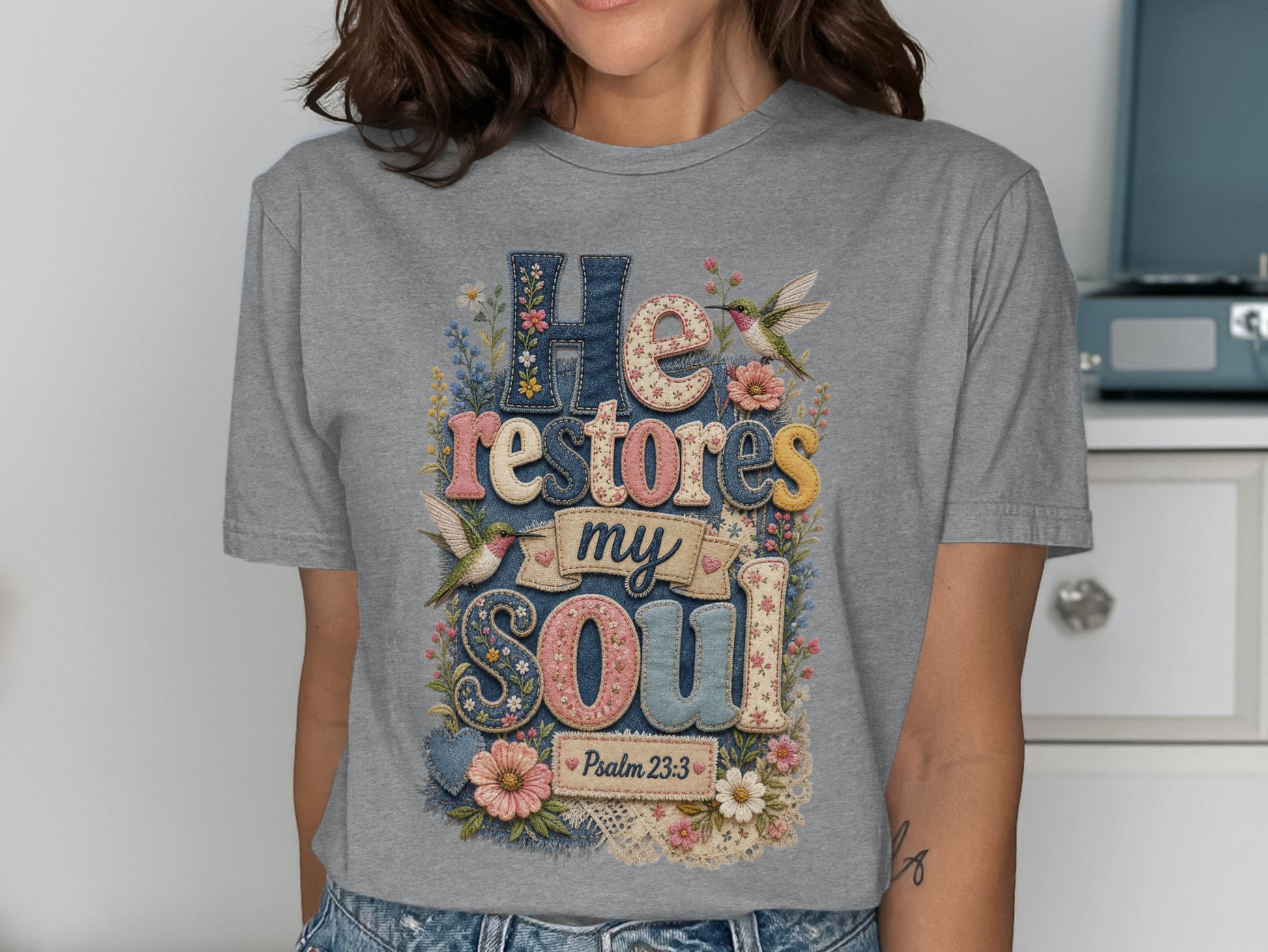 Grey t-shirt with "He Restores My Soul" in colorful, textured letters and Psalm 23:3.