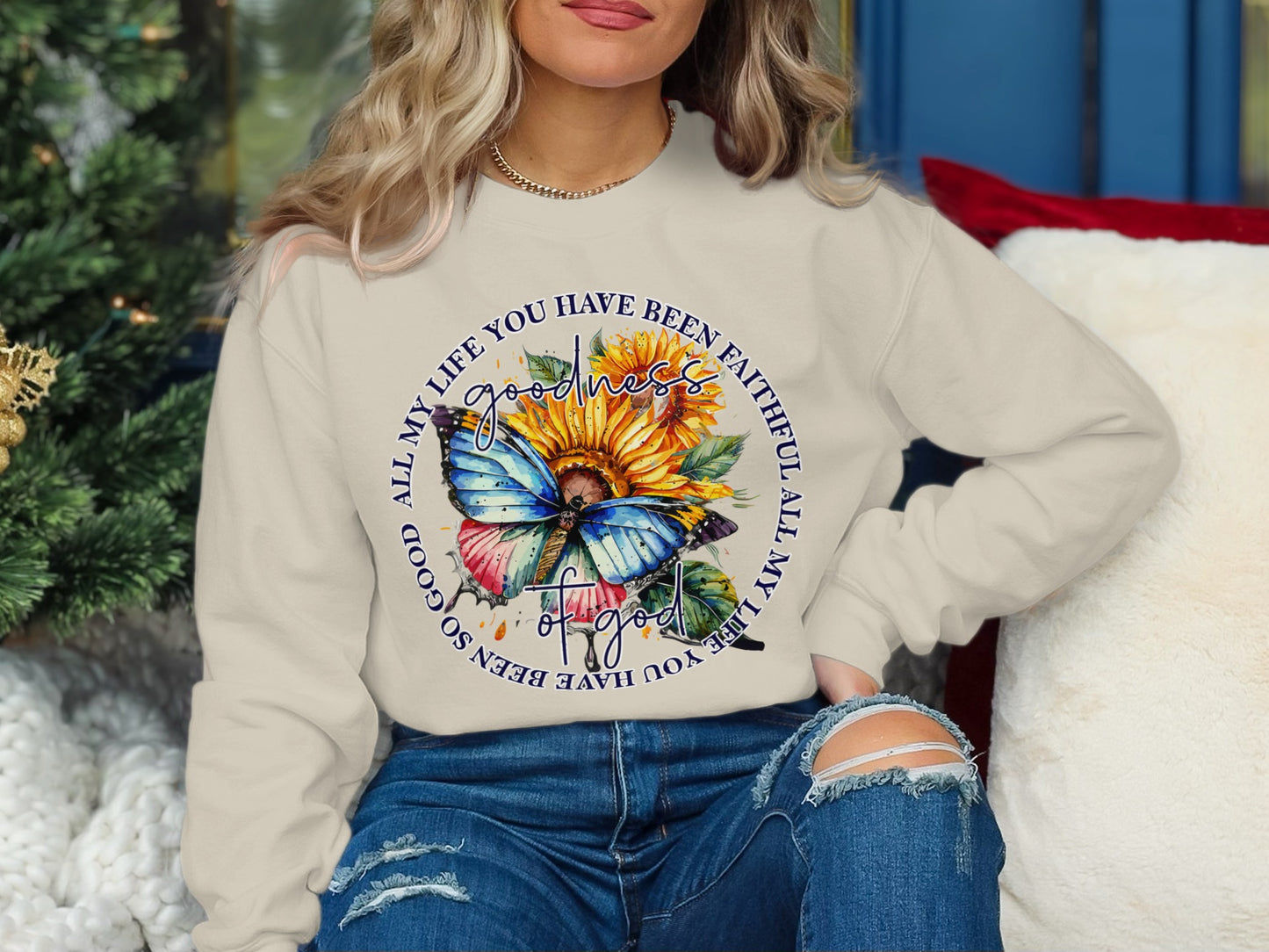 Cream sweatshirt with a butterfly and sunflower graphic, featuring text.