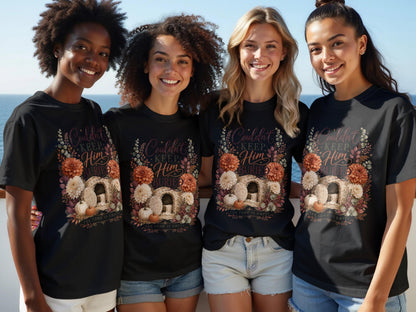 Four women wear black t-shirts with "Couldn't Keep Him Buried" and "The Tomb Is Empty" text.