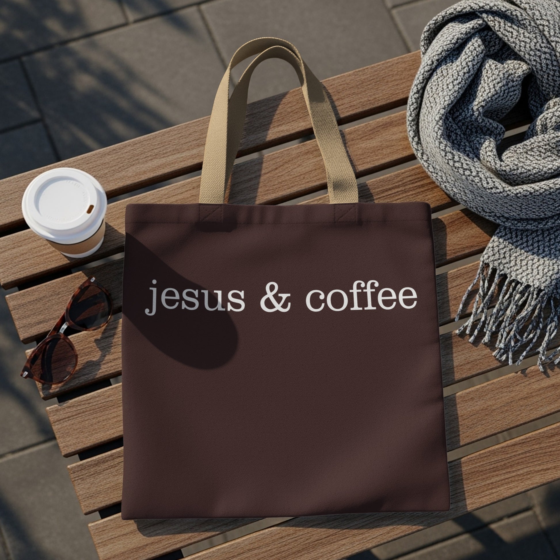 Brown tote bag with "Jesus & coffee" text, coffee cup, sunglasses, and scarf.