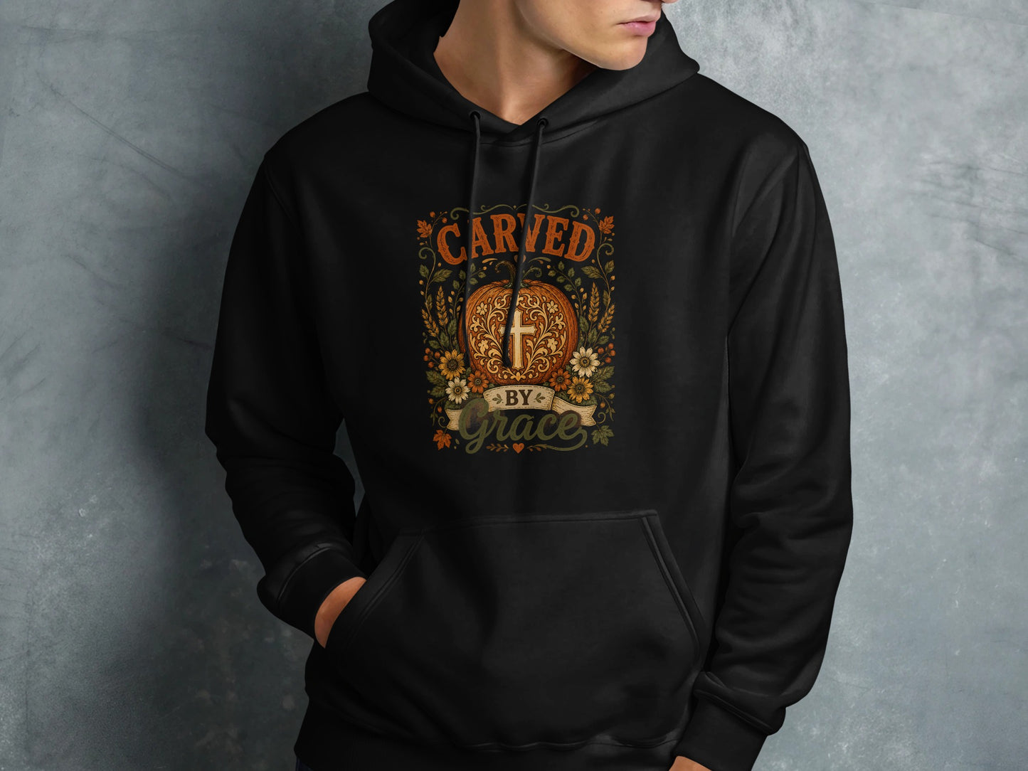 Black hoodie with "Carved by Grace" text and floral cross design.