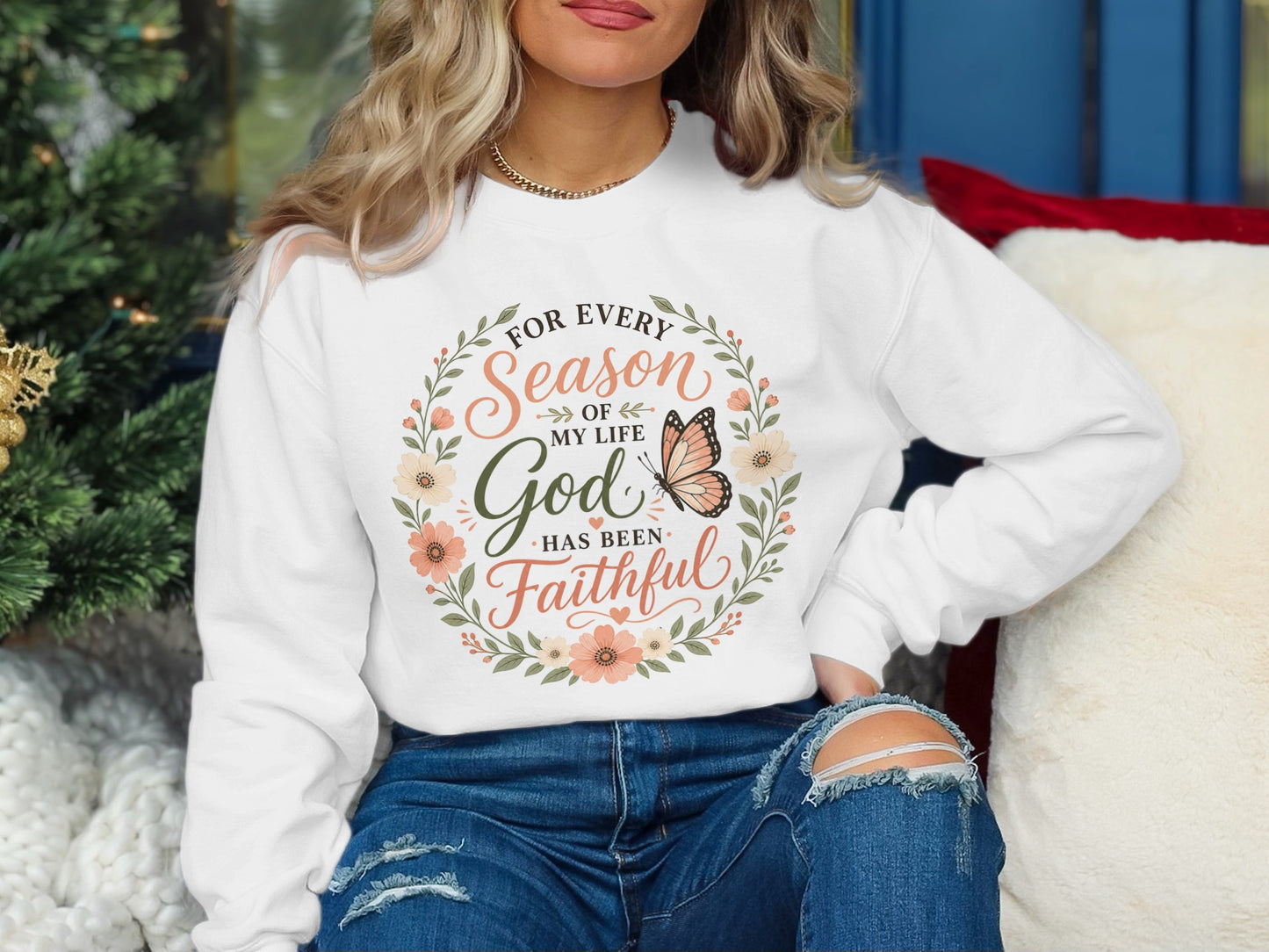 White sweatshirt with floral wreath and "For every season of my life God has been faithful" text.