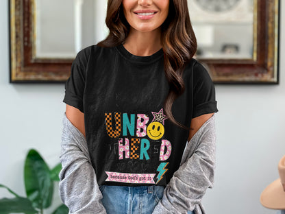 Black t-shirt with "Unbothered because God's got it" text and graphics.