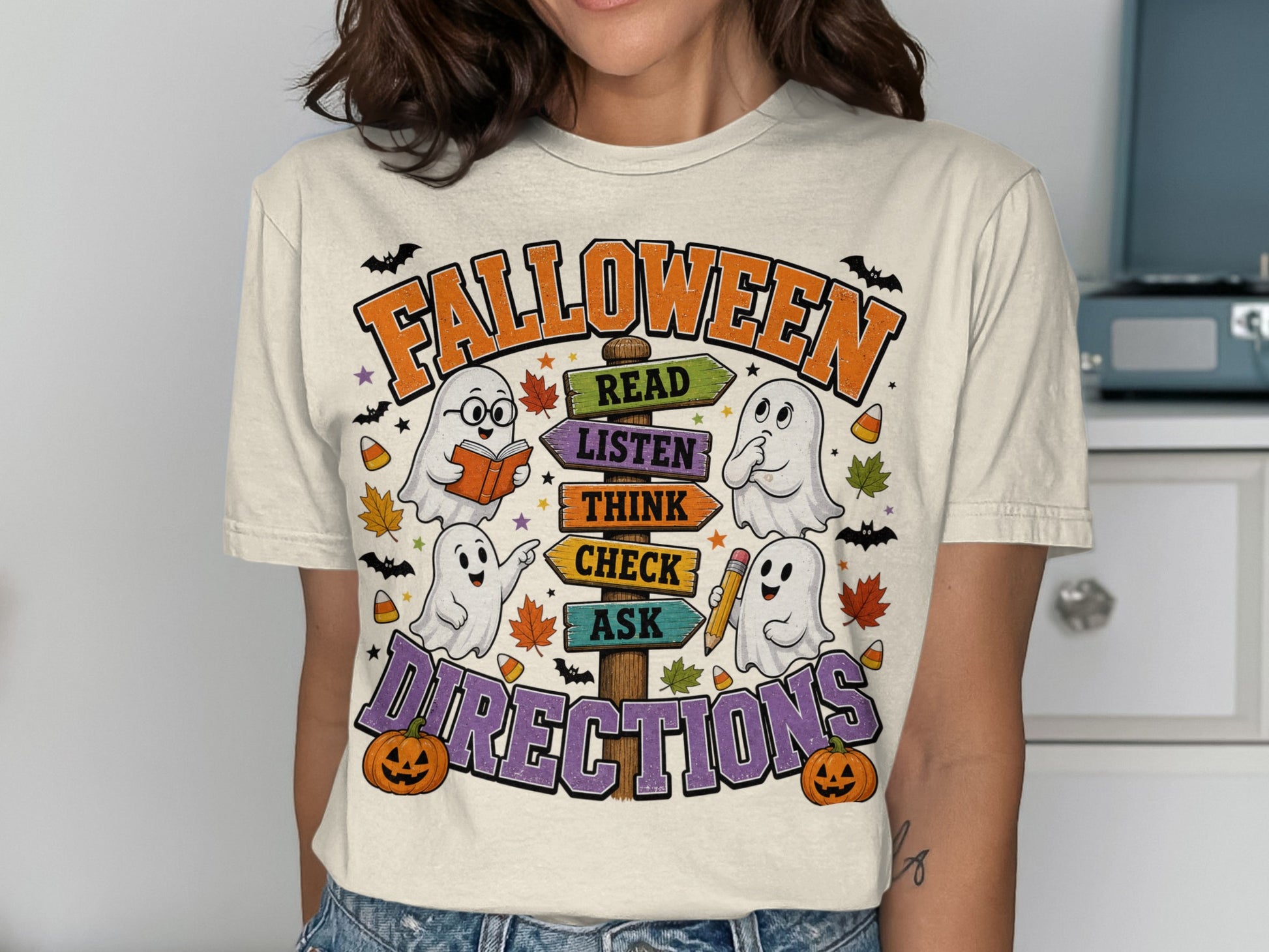 Halloween t-shirt with ghosts and directional signs reading "Read, Listen, Think, Check, Ask".