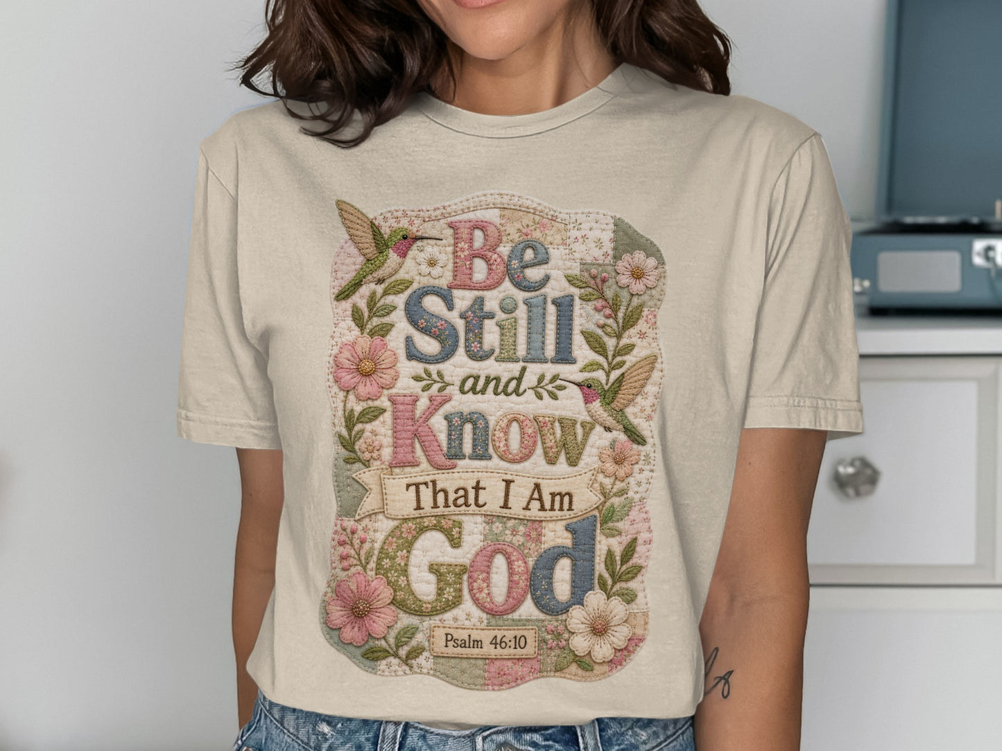 Floral t-shirt with "Be Still and Know That I Am God" text and hummingbirds.