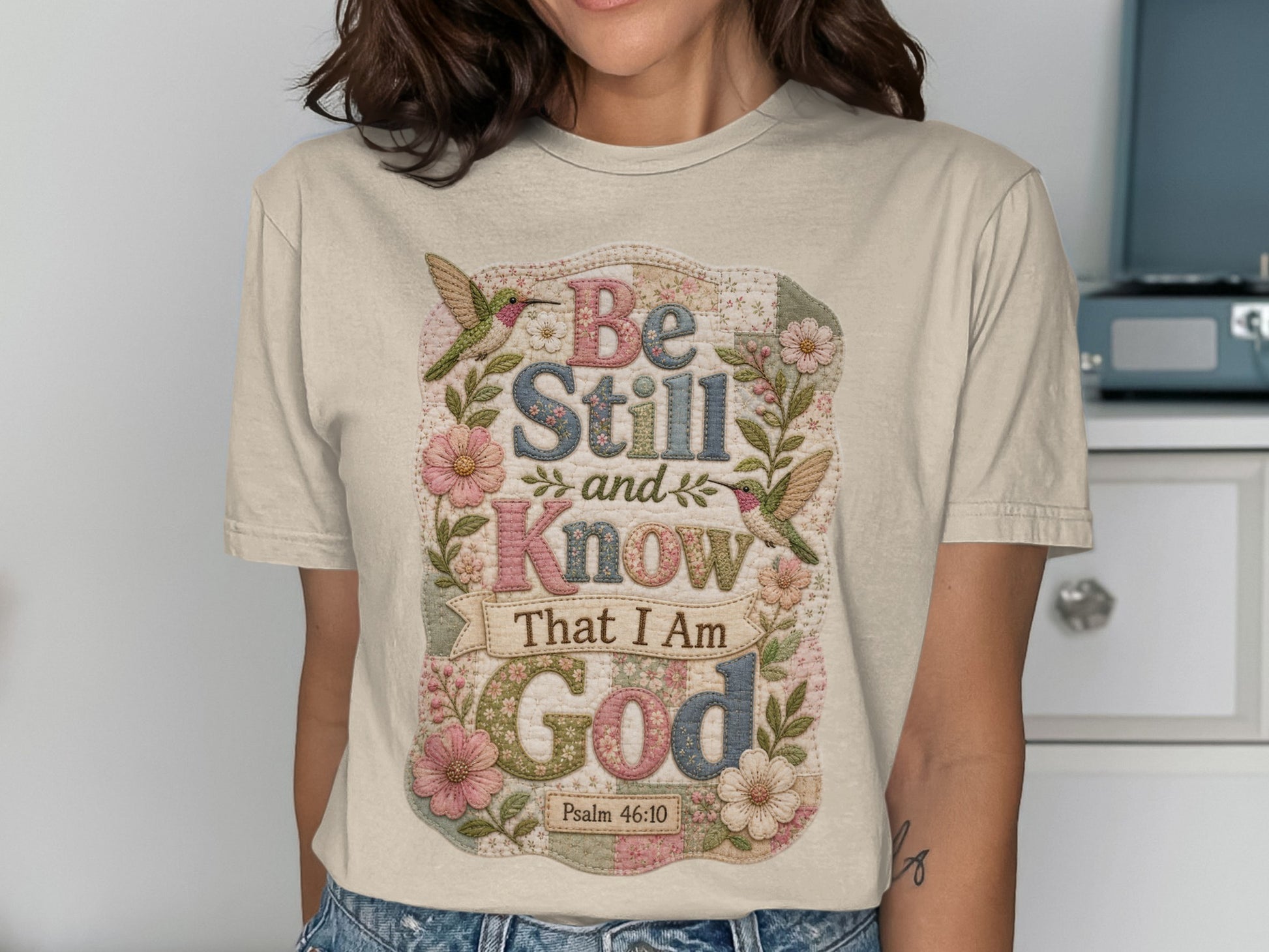 Floral t-shirt with "Be Still and Know That I Am God" text and hummingbirds.