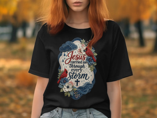 Black t-shirt with embroidered design: "Jesus carried me through every storm."