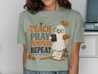 Ghost holding Holy Bible and pumpkin mug with text Teach Pray Pumpkin Repeat.