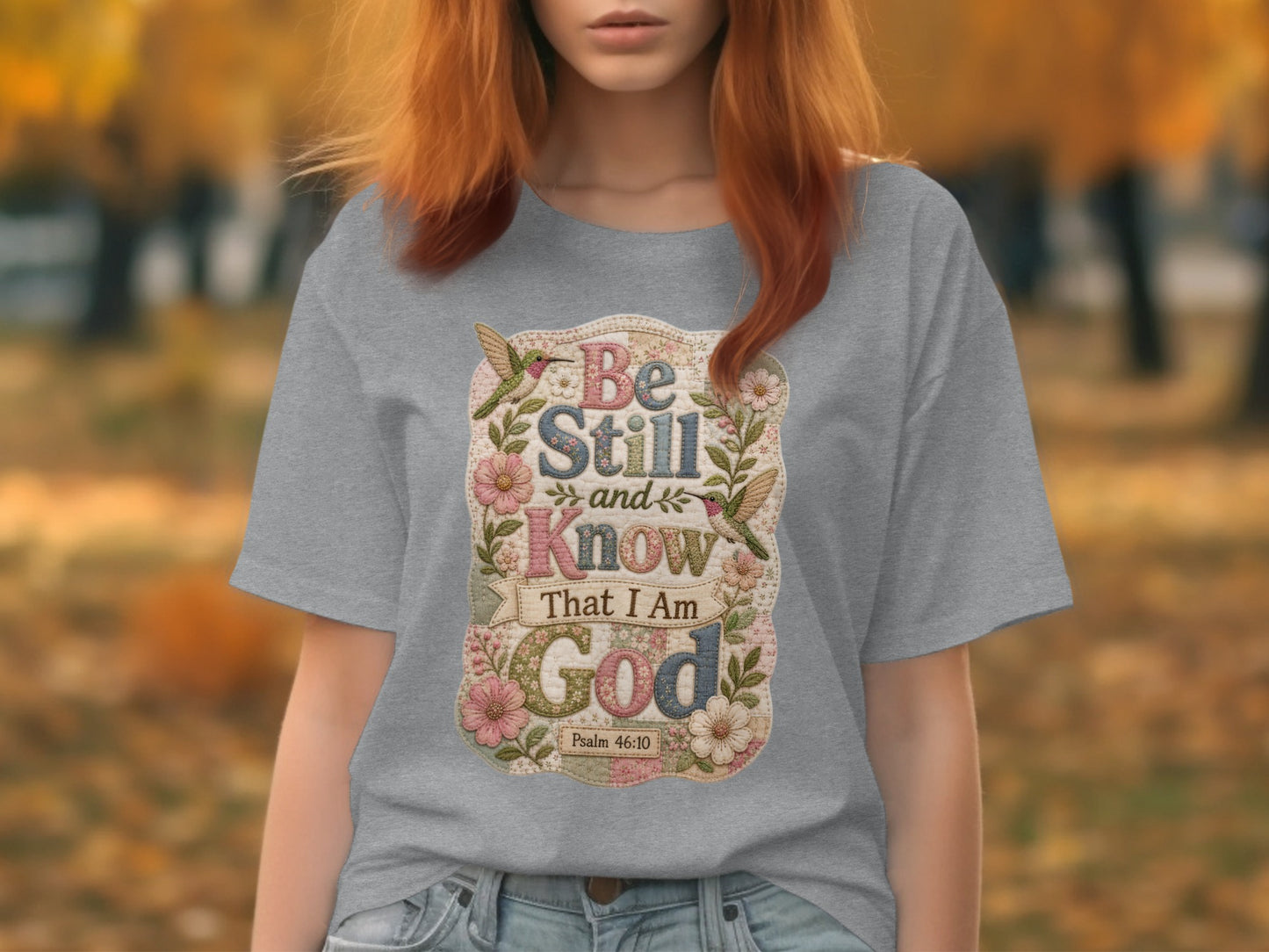 Gray t-shirt with "Be Still and Know That I Am God" text and floral accents.