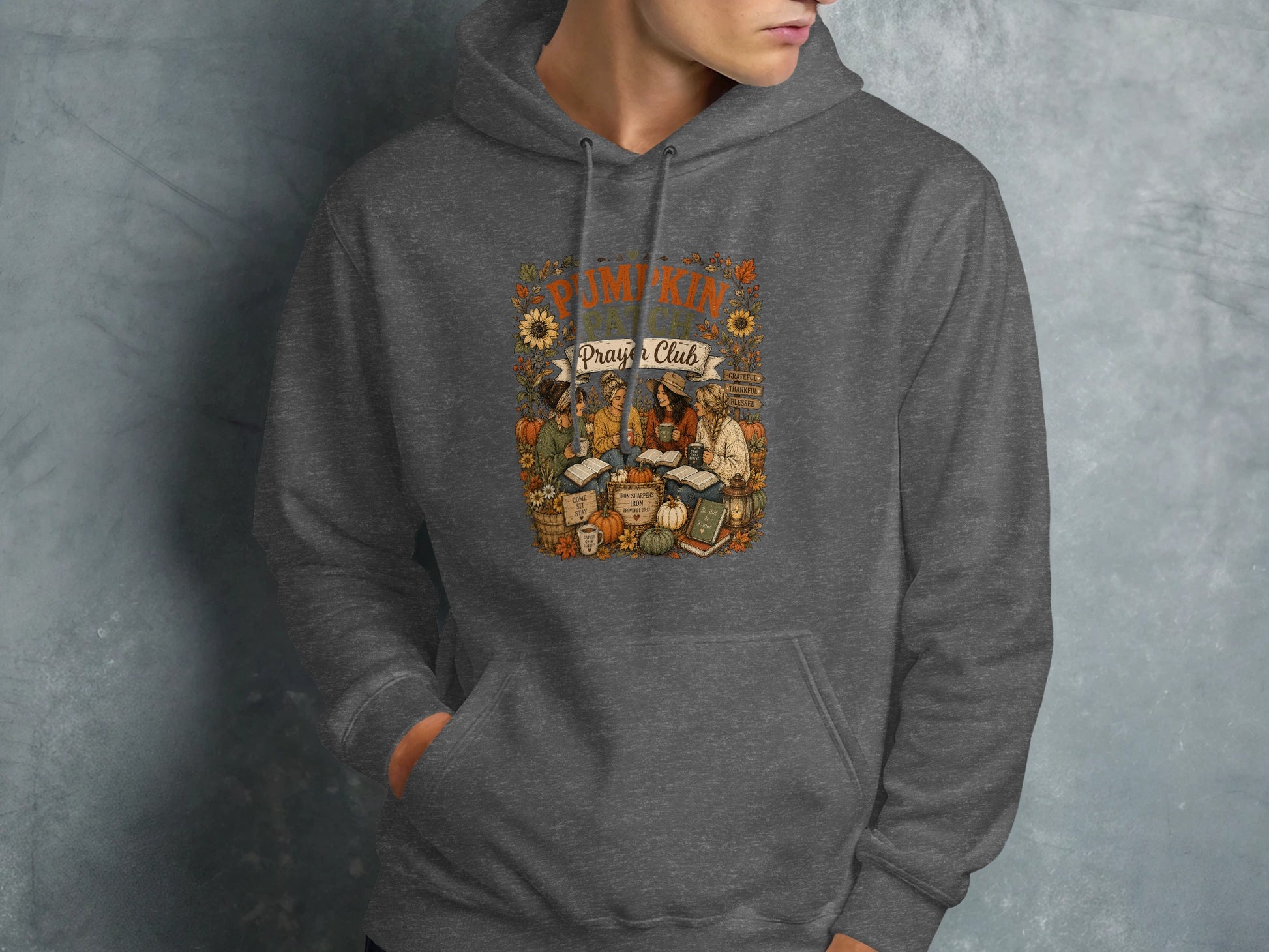 Dark grey hoodie with "Pumpkin Prayer Club" and Bible verses graphic.