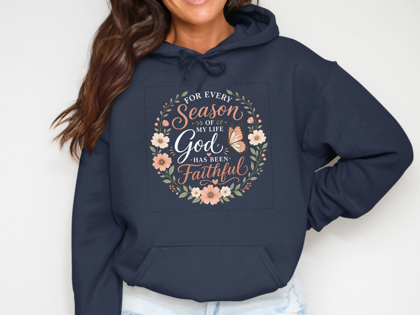 Navy hoodie with a floral wreath and "For every season of my life God has been faithful" text.