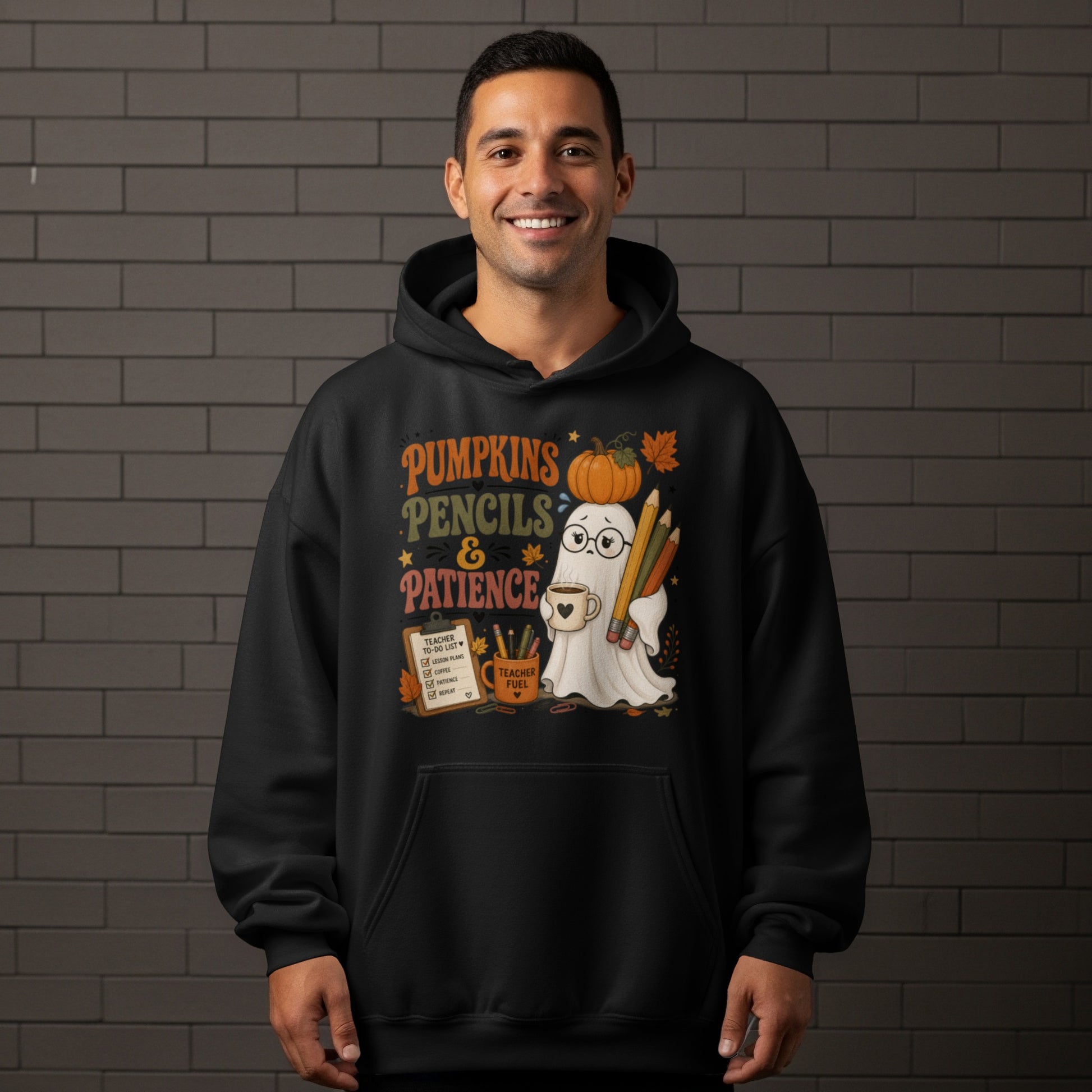 Ghost with pumpkin, pencils, and coffee on black hoodie reading "Pumpkins Pencils & Patience."