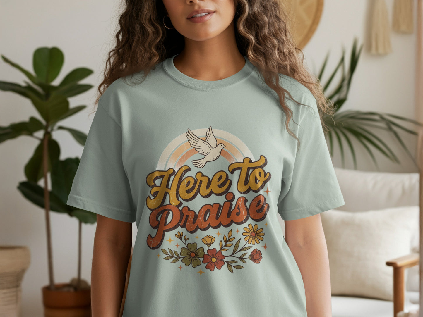 Light green t-shirt with "Here to Praise" text, a dove, and floral design.