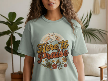 Light green t-shirt with "Here to Praise" text, a dove, and floral design.