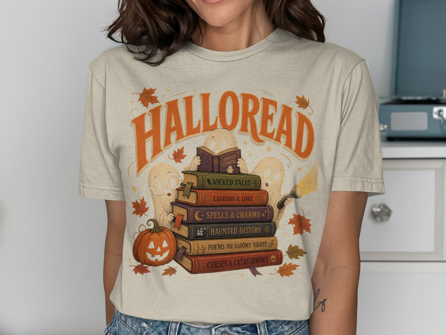 T-shirt graphic with "Halloread" title and stack of books featuring ghost illustrations.